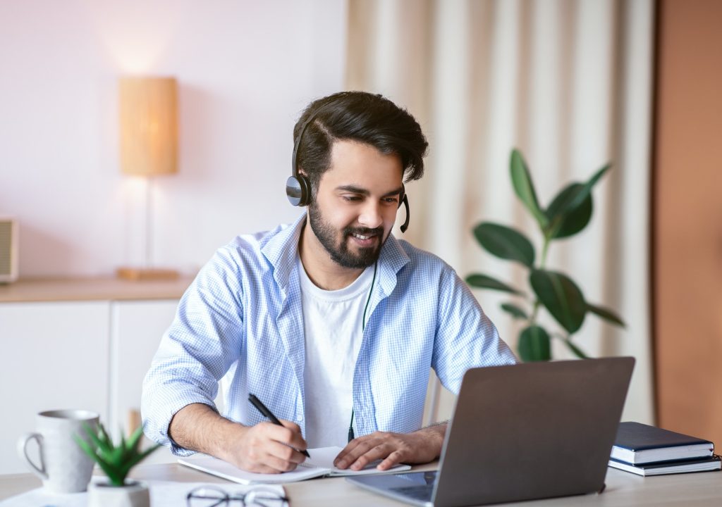 online-education-young-arab-guy-watching-webinar-on-laptop-and-taking-notes.jpg